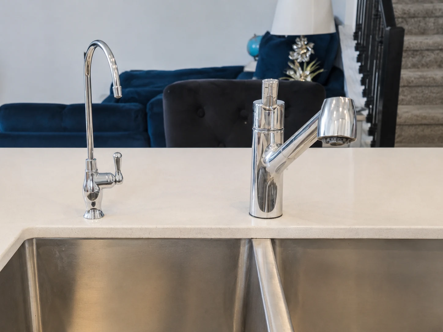 Polished chrome drinking-water faucet beside the main kitchen faucet